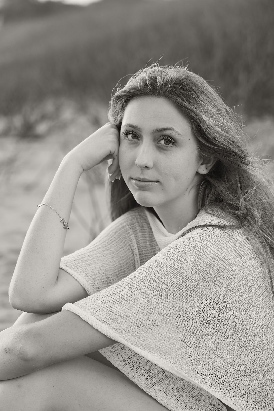 Close portrait, hand resting at her temple