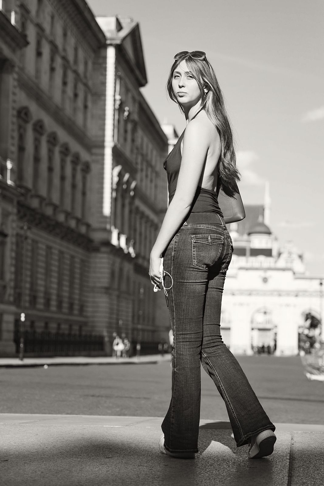 Full-length walking away, looking back over her shoulder
