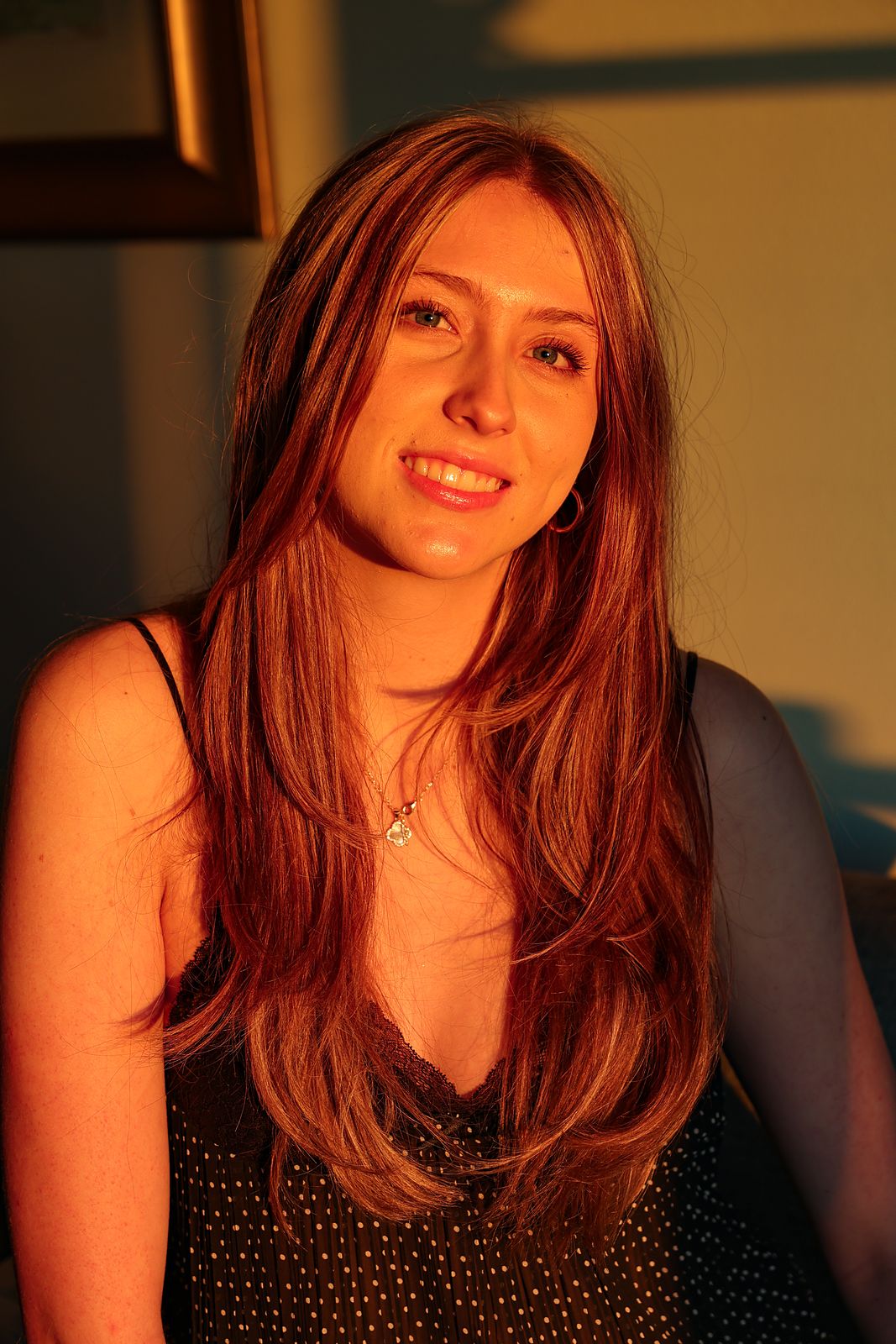Colour portrait in warm window light, smiling