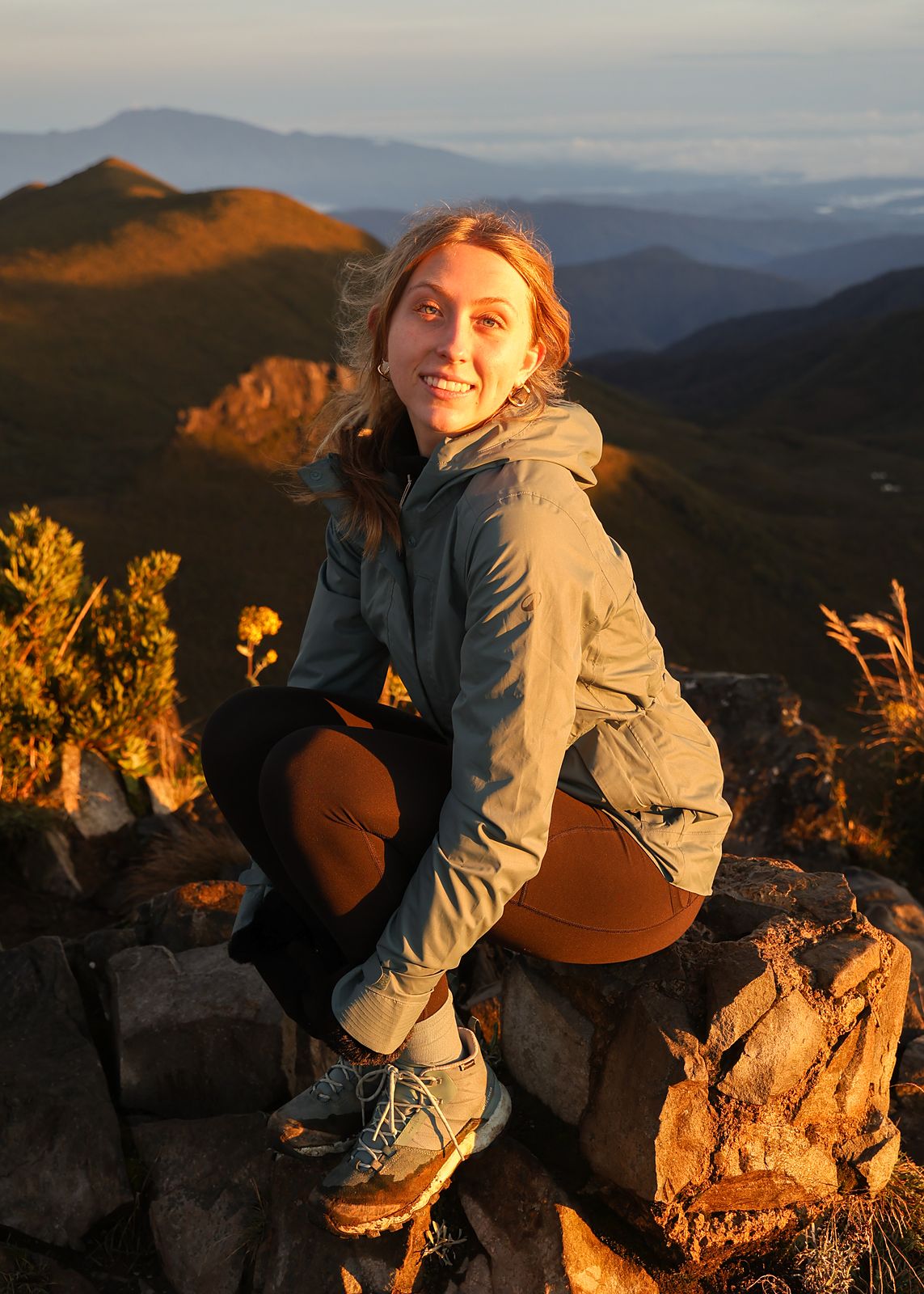 Colour, crouched on rocks at golden hour in the mountains
